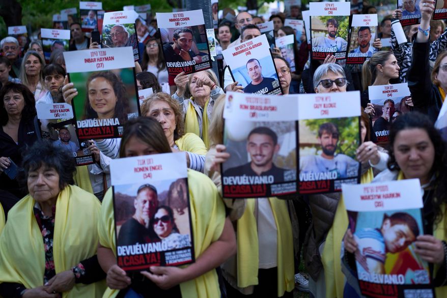 People gather in a park to demand Hamas the release of hostages who remain in captivity in Gaza, in Buenos Aires, Argentina, Tuesday, Oct. 7, 2025, on the two-year anniversary of Hamas' attack on Israel. (AP Photo/Rodrigo Abd)