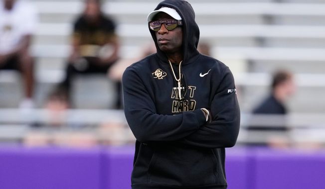 Colorado head coach Deion Sanders watches his team warm up before an NCAA college football game against TCU Saturday, Oct. 4, 2025, in Fort Worth, Texas. (AP Photo/Tony Gutierrez)