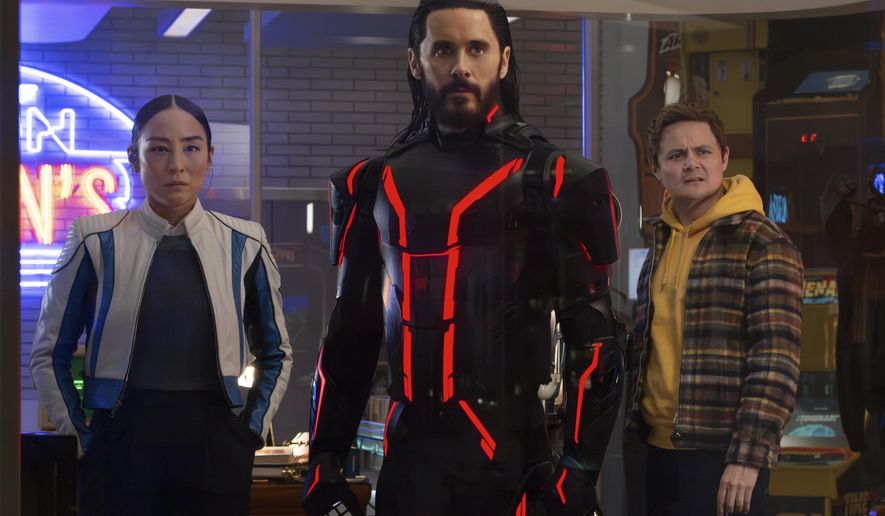 This image released by Disney shows Greta Lee, from left, Jared Leto and Arturo Castro in a scene from "Tron: Ares." (Disney via AP)