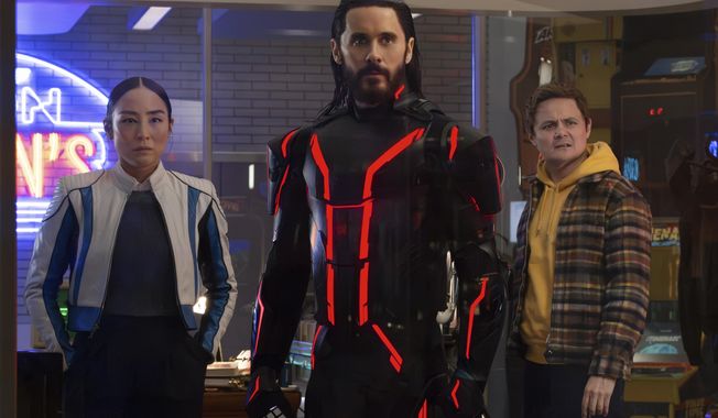 This image released by Disney shows Greta Lee, from left, Jared Leto and Arturo Castro in a scene from "Tron: Ares." (Disney via AP)