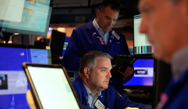 James Bodner, center, and others work on the floor at the New York Stock Exchange in New York, Wednesday, Oct. 1, 2025. (AP Photo/Seth Wenig) ** FILE **