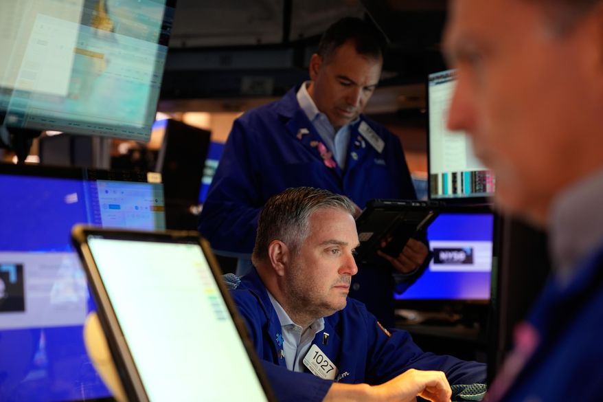 James Bodner, center, and others work on the floor at the New York Stock Exchange in New York, Wednesday, Oct. 1, 2025. (AP Photo/Seth Wenig) ** FILE **