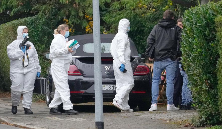 Forensic investigators appear at the crime scene at a street in Herdecke, Germany, Tuesday, Oct. 7, 2025, after the newly elected mayor of Herdecke, Iris Stalzer, has been found critically injured in her apartment. (AP Photo/Martin Meissner)