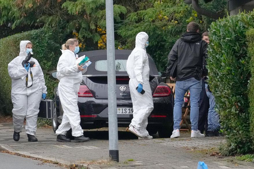 Forensic investigators appear at the crime scene at a street in Herdecke, Germany, Tuesday, Oct. 7, 2025, after the newly elected mayor of Herdecke, Iris Stalzer, has been found critically injured in her apartment. (AP Photo/Martin Meissner)