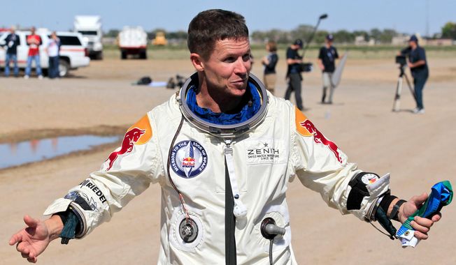 FILE - Felix Baumgartner of Austria gestures prior to speaking with the media after successfully jumping from a space capsule lifted by a helium balloon in Roswell, N.M., Oct. 14, 2012. (AP Photo/Ross D. Franklin, File)