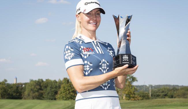 Charley Hull, of England, holds the trophy after winning the Kroger Queen City Championship golf tournament, Sunday, Sept. 14, 2025, at TPC River's Bend in Cincinnati. (AP Photo/Tanner Pearson)
