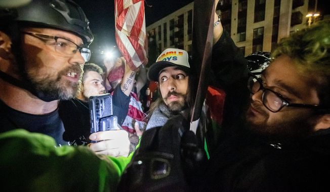Trump supporters and protesters argue over Israeli and Palestinians outside a U.S. Immigration and Customs Enforcement facility in Portland, Ore., Monday, Oct. 6, 2025. (AP Photo/Ethan Swope)