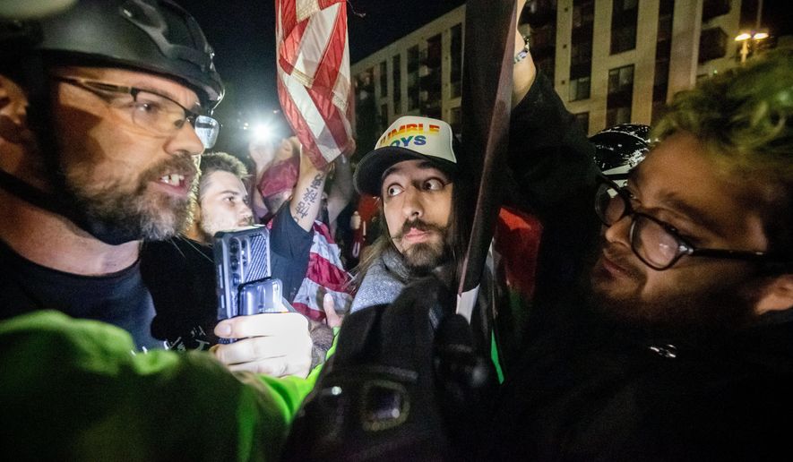 Trump supporters and protesters argue over Israeli and Palestinians outside a U.S. Immigration and Customs Enforcement facility in Portland, Ore., Monday, Oct. 6, 2025. (AP Photo/Ethan Swope)