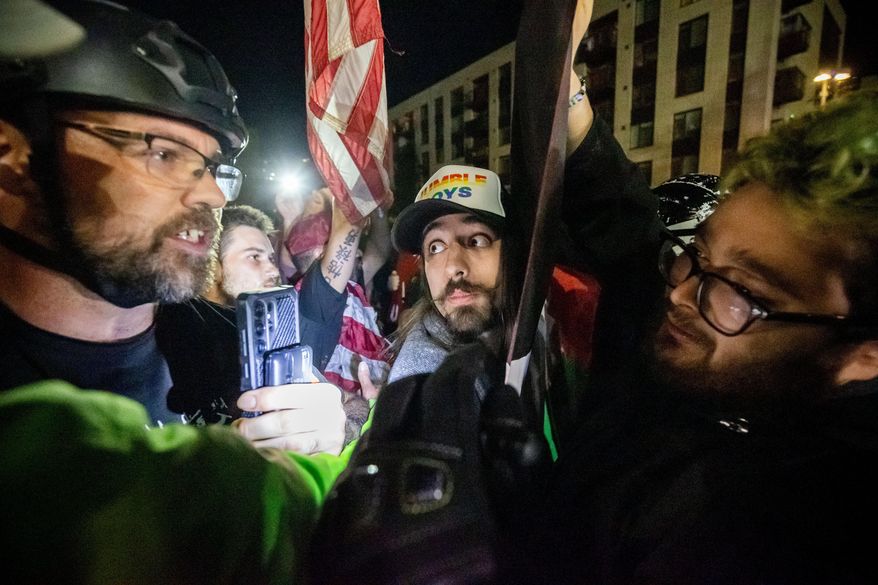 Trump supporters and protesters argue over Israeli and Palestinians outside a U.S. Immigration and Customs Enforcement facility in Portland, Ore., Monday, Oct. 6, 2025. (AP Photo/Ethan Swope)