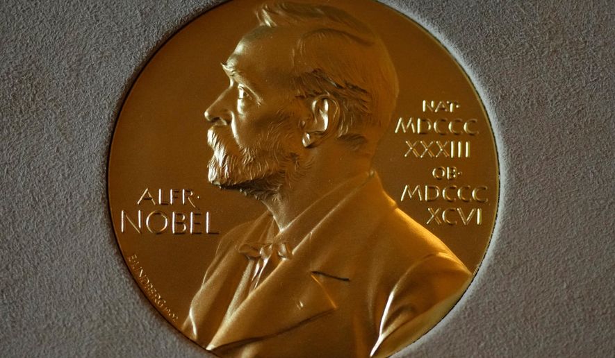 FILE - A Nobel Prize medal is displayed before a ceremony at the Swedish Ambassador's Residence in London, Monday, Dec. 6, 2021. (AP Photo/Matt Dunham, File)