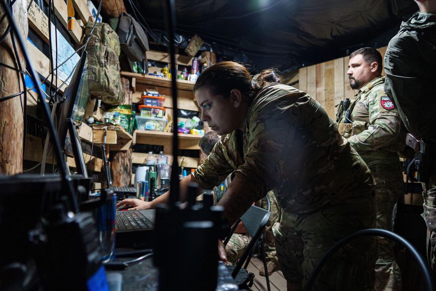A Ukrainian servicewoman callsign Fox, 33, of Safari Unit of Liut Brigade operate a recognisance drone at the frontline in Donetsk region, Ukraine, on Sept. 6, 2025. (AP Photo/Vasilisa Stepanenko)