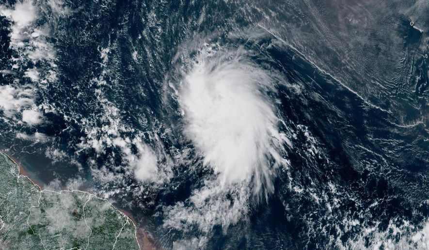 This satellite image provided by the National Oceanic and Atmospheric Administration (NOAA) shows Tropical Storm Jerry in the Atlantic Ocean, Tuesday, Oct. 7, 2025. (NOAA via AP)