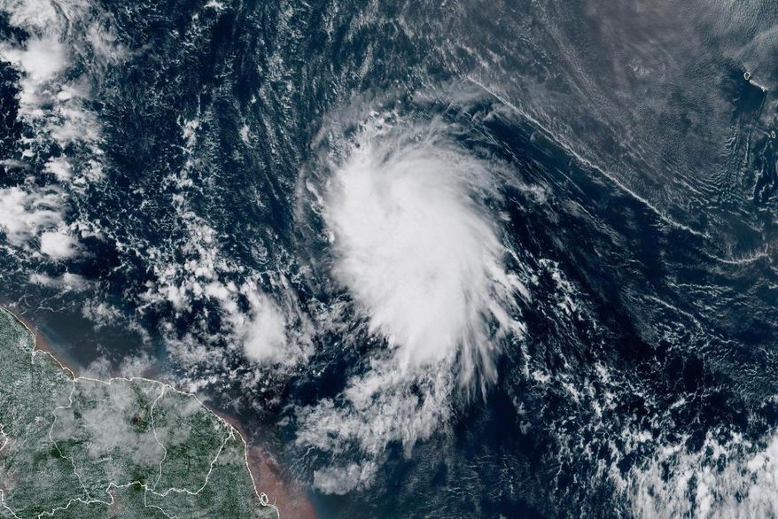 This satellite image provided by the National Oceanic and Atmospheric Administration (NOAA) shows Tropical Storm Jerry in the Atlantic Ocean, Tuesday, Oct. 7, 2025. (NOAA via AP)