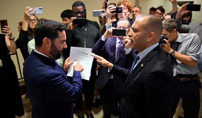 Rep. Michael Lawler, R-N.Y., left, confronts House Minority Leader Hakeem Jeffries, D-N.Y., in a heated discussion to endorse House bill H.R.5145 that would extend the American Rescue Plan Act of 2021 (ARPA) and the Inflation Reduction Act of 2022 at the U.S. Capitol on Wednesday, Oct. 8, 2025, in Washington. (AP Photo/John McDonnell)