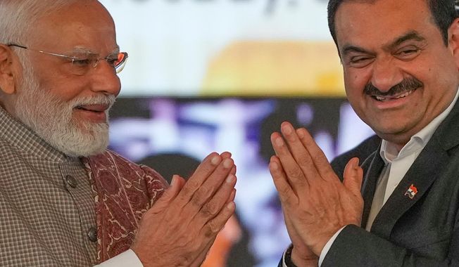 Indian Prime Minister Narendra Modi, left, greets Chairman Adani Group, Gautam Adani during the inauguration ceremony of the Navi Mumbai International Airport in Navi Mumbai, India, Wednesday, Oct. 8, 2025. (AP Photo/Rafiq Maqbool)