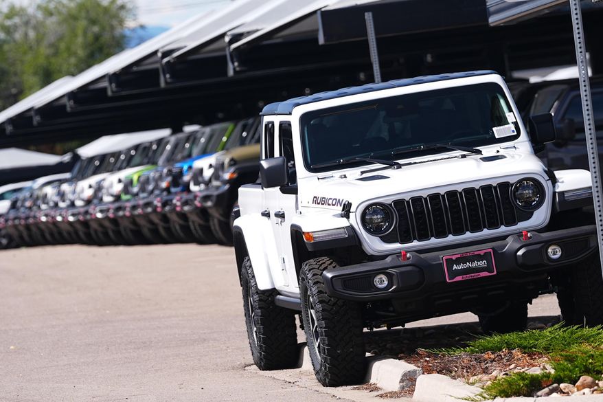 FILE - Unsold 2025 Gladiator pickup trucks sit on display outside a Jeep dealership Friday, Sept. 26, 2025, in Englewood, Colo. (AP Photo/David Zalubowski, File)