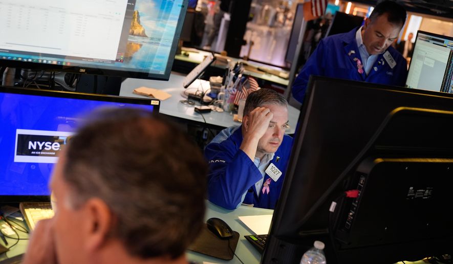 James Bodner, center, and others work on the floor at the New York Stock Exchange in New York, Wednesday, Oct. 1, 2025. (AP Photo/Seth Wenig)
