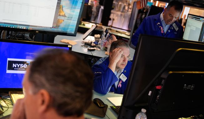 James Bodner, center, and others work on the floor at the New York Stock Exchange in New York, Wednesday, Oct. 1, 2025. (AP Photo/Seth Wenig)