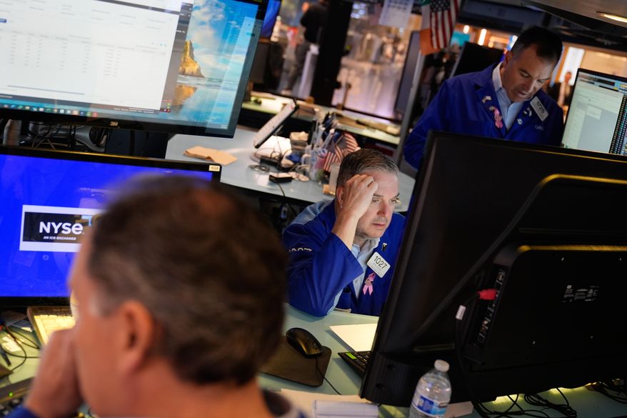 James Bodner, center, and others work on the floor at the New York Stock Exchange in New York, Wednesday, Oct. 1, 2025. (AP Photo/Seth Wenig)