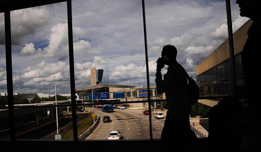 Passengers walk from a terminal at Philadelphia International Airport in Philadelphia, Tuesday, Oct. 7, 2025. (AP Photo/Matt Rourke)