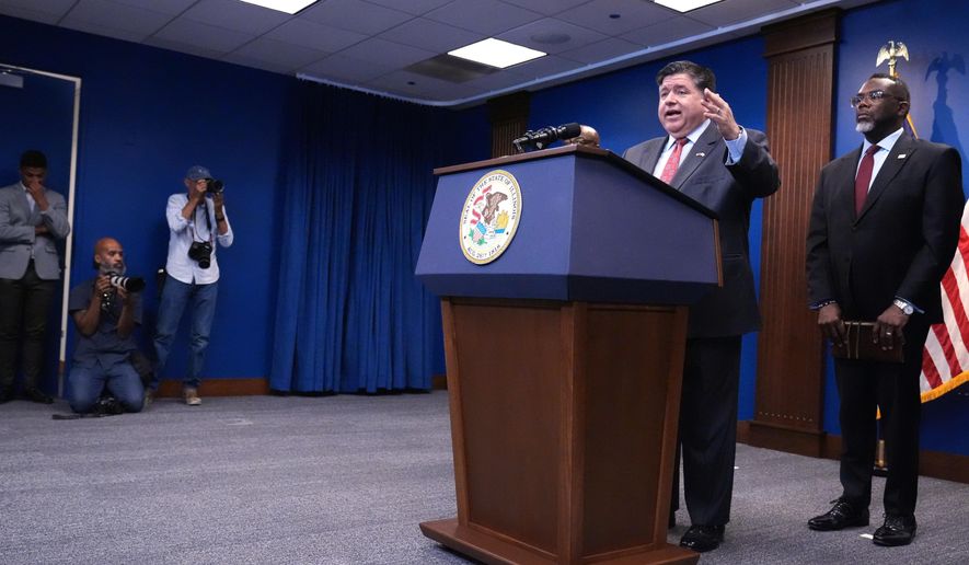 Governor JB Pritzker, second from right, speaks as Chicago Mayor Brandon Johnson, right, listens to him at a news conference in Chicago, Monday, Oct. 6, 2025. (AP Photo/Nam Y. Huh)