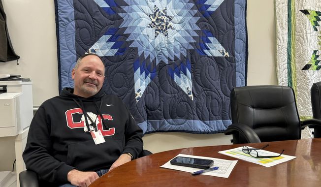 In this photo provided by South Dakota News Watch, Rob Coverdale, superintendent of the Crow Creek Tribal School District in Stephan, S.D., poses for a photo in his office, Feb. 7, 2025. (Bart Pfankuch/South Dakota News Watch via AP)