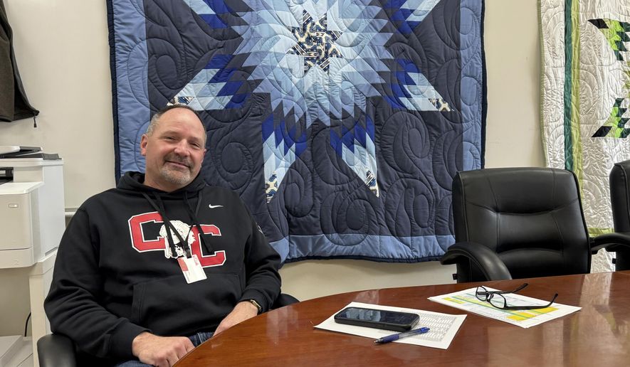 In this photo provided by South Dakota News Watch, Rob Coverdale, superintendent of the Crow Creek Tribal School District in Stephan, S.D., poses for a photo in his office, Feb. 7, 2025. (Bart Pfankuch/South Dakota News Watch via AP)