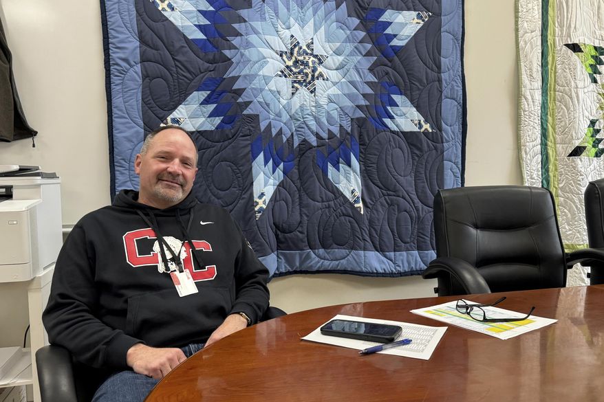 In this photo provided by South Dakota News Watch, Rob Coverdale, superintendent of the Crow Creek Tribal School District in Stephan, S.D., poses for a photo in his office, Feb. 7, 2025. (Bart Pfankuch/South Dakota News Watch via AP)