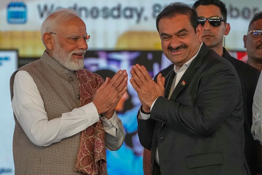 Indian Prime Minister Narendra Modi, left, greets Chairman Adani Group, Gautam Adani during the inauguration ceremony of the Navi Mumbai International Airport in Navi Mumbai, India, Wednesday, Oct. 8, 2025. (AP Photo/Rafiq Maqbool)