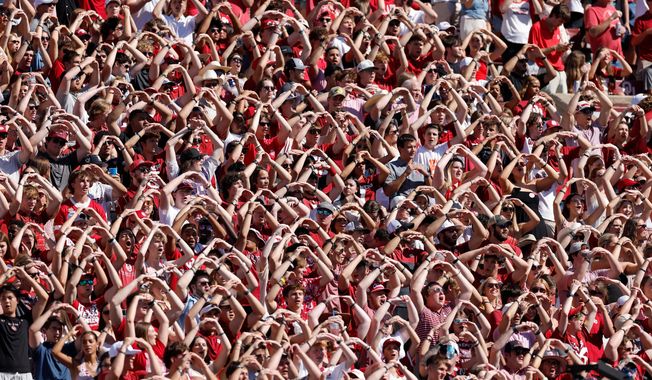 Oklahoma fans cheer for their team during the first half of an NCAA college football game against Kent State, Saturday, Oct. 4, 2025, in Norman, Okla. (AP Photo/Alonzo Adams)