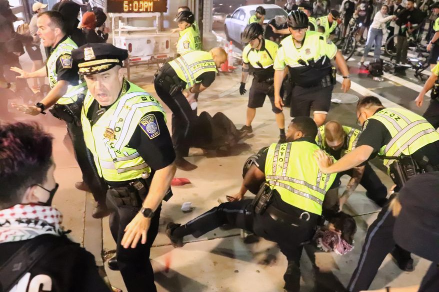In this photo provided by Bryan Hecht, law enforcement detain a pro-Palestinian protester Tuesday, Oct. 7, 2025, in Boston. (Bryan Hecht/The Berkeley Beacon via AP)