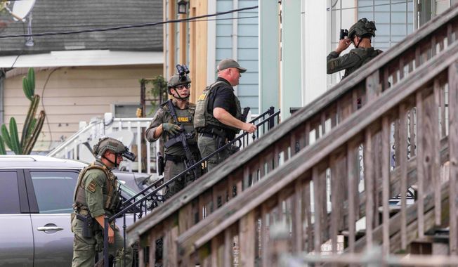 FILE - Law enforcement search for a fugitive that escaped a prison in New Orleans, May 21, 2025. (Chris Granger/The Times-Picayune/The New Orleans Advocate via AP, File)