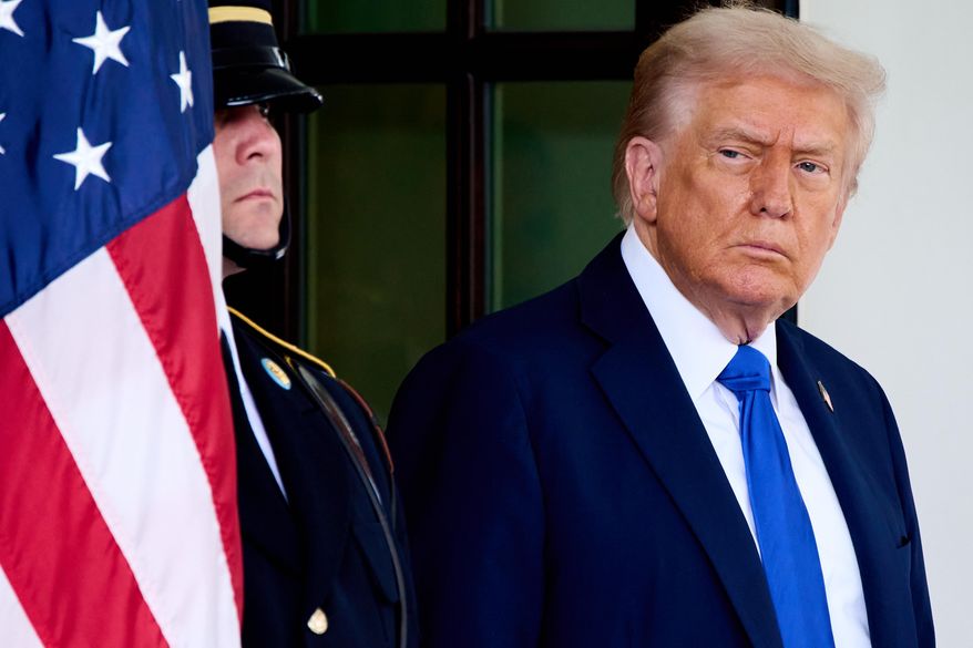 President Donald Trump waits to greet Canada's Prime Minister Mark Carney, as Carney arrives at the White House, Tuesday, Oct. 7, 2025, in Washington. (AP Photo/Jacquelyn Martin)