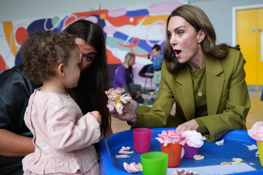 Kate, the princess of Wales, interacts with children as she visits Home-Start Oxford to meet and talk to families, and the volunteers who support them, in Oxford, England, Thursday, Oct. 9, 2025. (AP Photo/Kirsty Wigglesworth, Pool)
