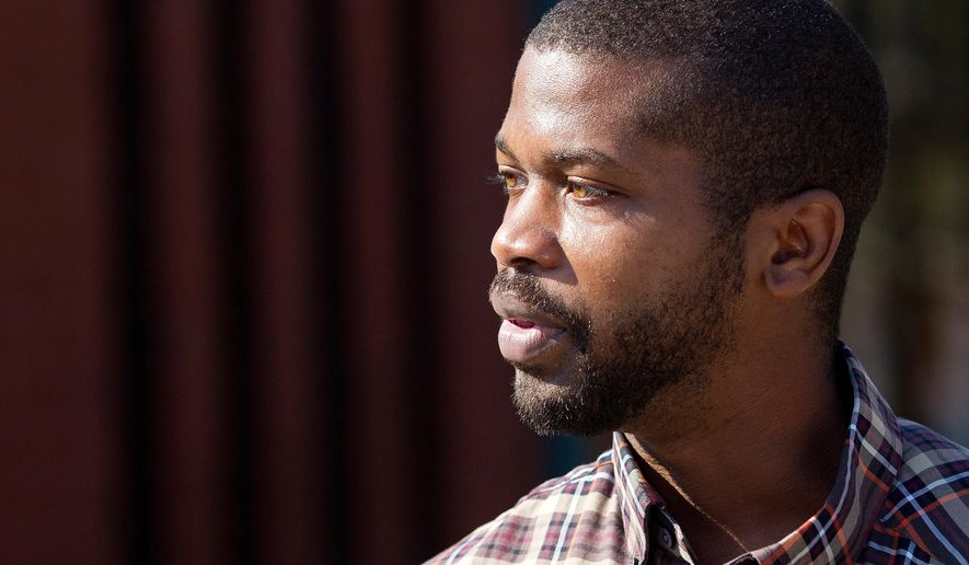 CORRECTS SOURCE TO NEWS&RECORD = N.C. House Rep. Cecil Brockman talks with early voters at Brown Recreation Center, on Wednesday, Nov. 2, 2016, in Greensboro, N.C. (Joseph Rodriguez/News & Record via AP)