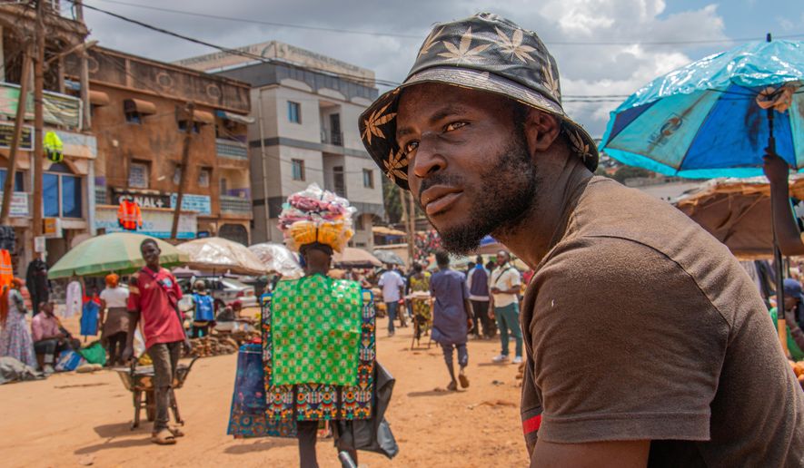 Bodio Merlin Cedric, 25, a porter, poses at Mokolo market, Yaoundé, Cameroon, Sept. 12, 2025. (AP Photo / Welba Yamo Pascal)