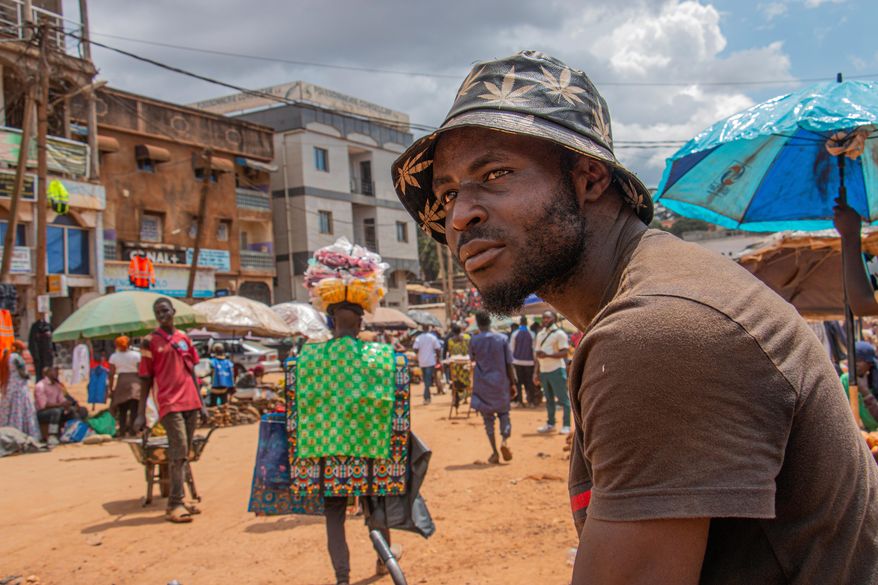 Bodio Merlin Cedric, 25, a porter, poses at Mokolo market, Yaoundé, Cameroon, Sept. 12, 2025. (AP Photo / Welba Yamo Pascal)