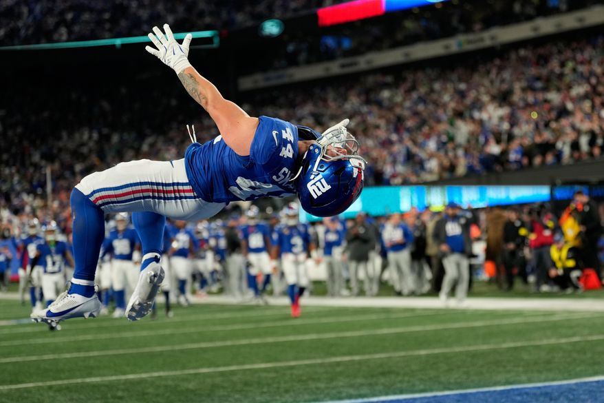 New York Giants' Cam Skattebo reacts after a touchdown during the second half of an NFL football game against the Philadelphia Eagles Thursday, Oct. 9, 2025, in East Rutherford, N.J. (AP Photo/Seth Wenig)