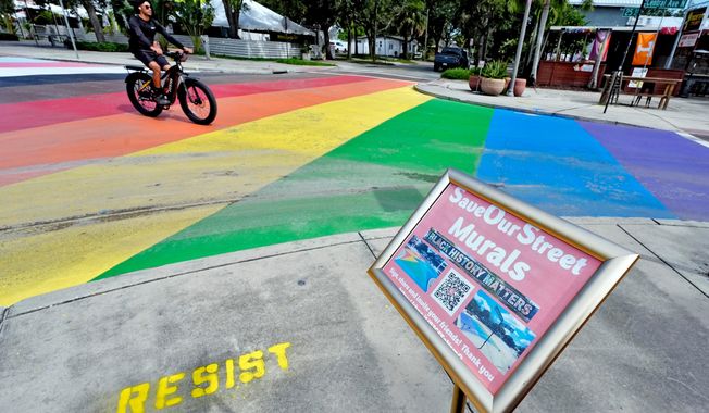 FILE - A cyclist crosses a rainbow-painted intersection, Aug. 27, 2025, in St. Petersburg, Fla. (AP Photo/Chris O'Meara, file)