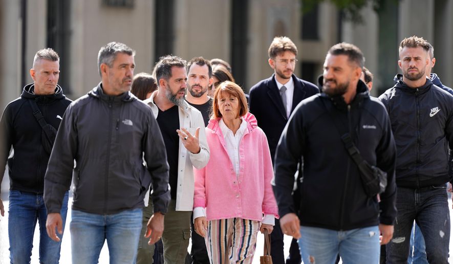 Gisele Pelicot and her son Florian Pelicot, third left, return to the courthouse during the appeals trial in the case of a man challenging his conviction, less than a year after the landmark verdict in a drugging and rape trial that shook France Thursday, Oct. 9, 2025 in Nimes, southern France. (AP Photo/Lewis Joly)