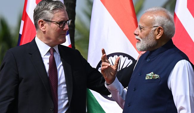 British Prime Minister Keir Starmer, left is greeted by Indian Prime Minister Narendra Modi on his arrival at Raj Bhavan in Mumbai, India, Thursday, Oct. 9, 2025. (Leon Neal/Pool Photo via AP)