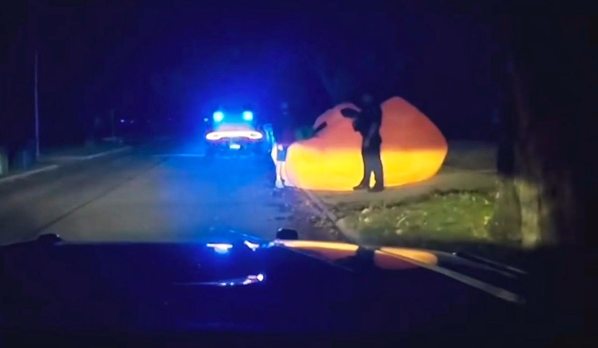 NextImg:After a police pursuit of a huge inflatable pumpkin, body cam video shows officer struggling with it