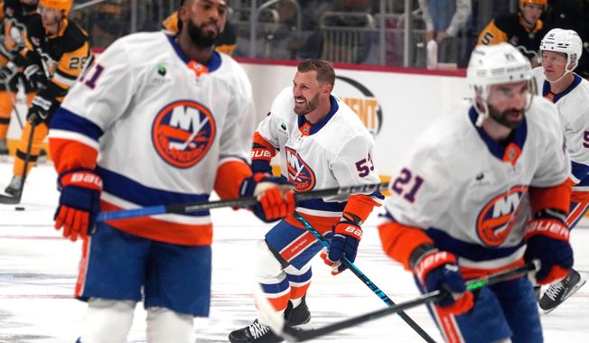 New York Islanders' Casey Cizikas, center, Anthony Duclair, left, and Kyle Palmieri (21) skate during warm ups before an NHL hockey game against the Pittsburgh Penguins in Pittsburgh, Thursday, Oct. 9, 2025. (AP Photo/Gene J. Puskar)