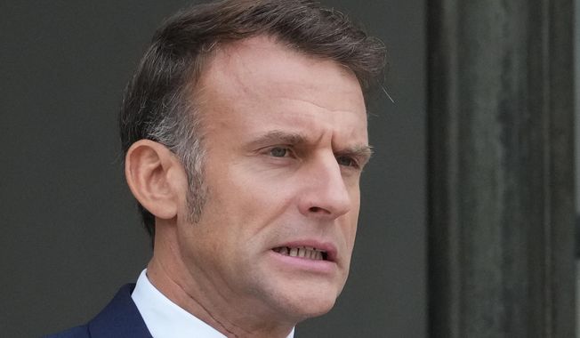 French President Emmanuel Macron waits for Jordan's Crown Prince Hussein at the presidential Elysee Palace, Wednesday, Oct. 8, 2025 in Paris. (AP Photo/Michel Euler)