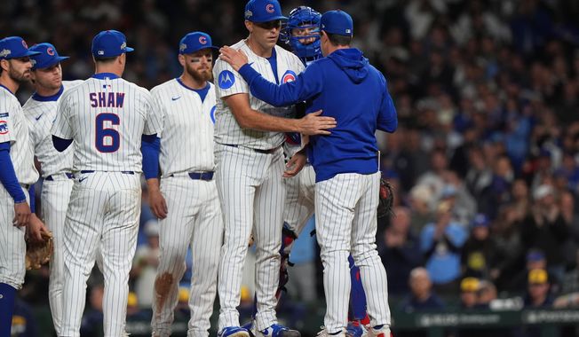 Chicago Cubs manager Craig Counsell acknowledges starting pitcher Matthew Boyd (16) while making a pitching change during the fifth inning of Game 4 of baseball's National League Division Series against the Milwaukee Brewers Thursday, Oct. 9, 2025, in Chicago. (AP Photo/Nam Y. Huh)
