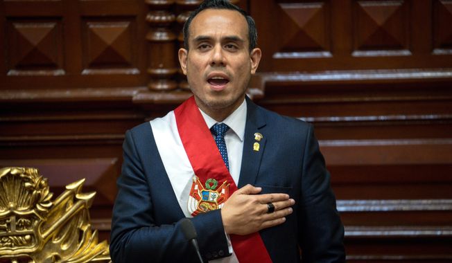 Peru's former president of the Congress Jose Jeri, sings the national anthem after being sworn-in as the interim president in Lima, Peru, Friday, Oct. 10, 2025. (AP Photo/John Reyes)
