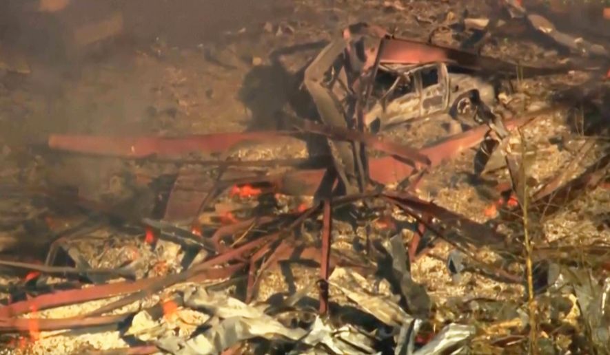Debris covers the ground and vehicles after a powerful blast ripped through a military explosives manufacturing plant in Hickman County, Tenn., on Friday, Oct. 10, 2025. (WTVF-TV via AP)