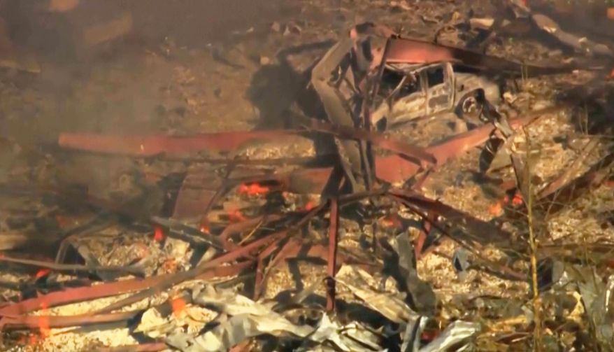 Debris covers the ground and vehicles after a powerful blast ripped through a military explosives manufacturing plant in Hickman County, Tenn., on Friday, Oct. 10, 2025. (WTVF-TV via AP)