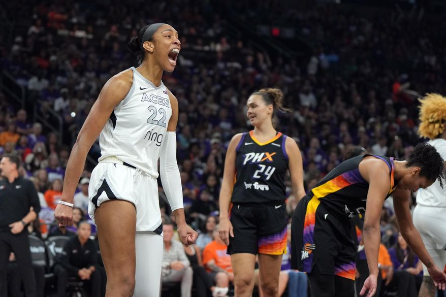 Las Vegas Aces center A'ja Wilson (22) reacts after scoring against the Phoenix Mercury during the first half of Game 4 of the WNBA basketball finals, Friday, Oct. 10, 2025, in Phoenix. (AP Photo/Rick Scuteri)