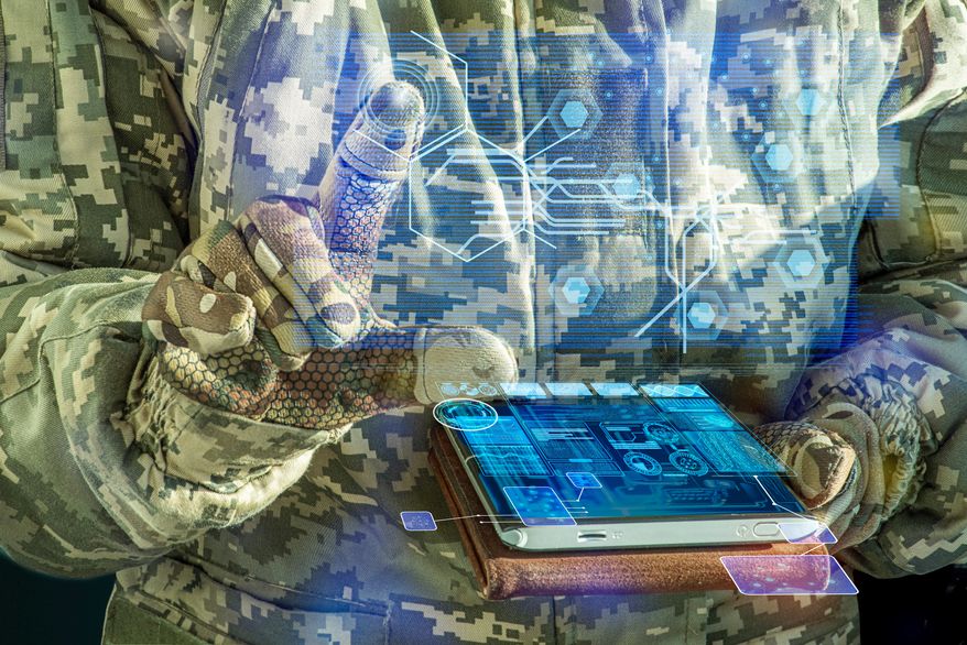 21st-century data dominance and the high-stakes data arms race between the U.S. and its adversaries. AI Command of the military forces on the tablet computer with augmented reality. File photo credit: TSViPhoto via Shutterstock.